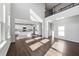 A sun-drenched living room with hardwood floors leading to a kitchen with an island and stainless appliances at 6935 Melody Dr, Buford, GA 30518