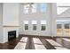 Bright living room featuring a fireplace, hardwood floors, large windows, and a door to a deck at 6935 Melody Dr, Buford, GA 30518