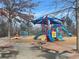 Playground with slides, climbing structures, and picnic tables on a sunny day at 6935 Melody Dr, Buford, GA 30518