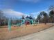 Another view of the playground featuring swings and additional slides with a wood chip base at 6935 Melody Dr, Buford, GA 30518