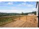 A wooden deck with a railing overlooks a treeline at 6935 Melody Ridge Rd, Buford, GA 30518