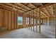 Unfinished basement with framed walls, concrete floor and natural light at 6935 Melody Ridge Rd, Buford, GA 30518