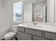 Bright bathroom with a white vanity, tub, and a window offering natural light at 6935 Melody Ridge Rd, Buford, GA 30518