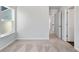 Bedroom with neutral carpet, natural light and access to the hallway at 6935 Melody Ridge Rd, Buford, GA 30518