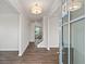 Inviting foyer features laminate flooring, a view of the staircase, and contemporary lighting at 6935 Melody Ridge Rd, Buford, GA 30518