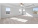 Large main bedroom featuring tray ceiling, large windows, and neutral carpet at 6935 Melody Ridge Rd, Buford, GA 30518