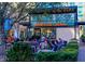 Outdoor seating area at Jeni's Ice Creams, featuring comfortable blue lounge chairs and lush greenery at 6935 Melody Ridge Rd, Buford, GA 30518