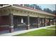 Brick restroom structure with multiple stalls and shaded walkway near playground for visitor's convenience at 6935 Melody Ridge Rd, Buford, GA 30518