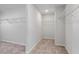 Large walk-in closet with neutral carpeting at 6935 Melody Dr, Buford, GA 30518