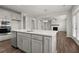 Open concept kitchen with gray cabinets, quartz countertops and island at 6939 Melody Dr, Buford, GA 30518