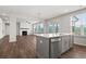 Open concept kitchen with gray cabinets, quartz countertops and island at 6939 Melody Dr, Buford, GA 30518