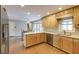 Kitchen with light wood cabinets, stainless steel appliances, and granite countertops at 1609 Wellshire Ln, Dunwoody, GA 30338