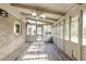 Large screened porch with wood flooring and ceiling fan at 1609 Wellshire Ln, Dunwoody, GA 30338