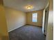 Simple bedroom with carpet flooring and neutral wall color at 5449 Martins Crossing Rd, Stone Mountain, GA 30088