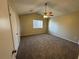 Large carpeted bedroom with ceiling fan and window at 5449 Martins Crossing Rd, Stone Mountain, GA 30088