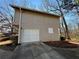 Detached garage with white door and neutral exterior at 5449 Martins Crossing Rd, Stone Mountain, GA 30088