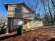 Two-story house needing repairs, featuring a green recycle bin at 5449 Martins Crossing Rd, Stone Mountain, GA 30088