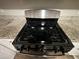 Close up of gas cooktop with stainless steel accents at 5449 Martins Crossing Rd, Stone Mountain, GA 30088