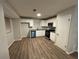 Modern kitchen with white cabinets, granite counters, and stainless steel appliances at 5449 Martins Crossing Rd, Stone Mountain, GA 30088