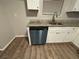 Close-up view of kitchen sink and dishwasher; granite countertop at 5449 Martins Crossing Rd, Stone Mountain, GA 30088