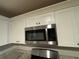 Microwave installed above cabinets in the kitchen at 5449 Martins Crossing Rd, Stone Mountain, GA 30088