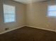 Bright bedroom featuring neutral walls and carpeted floors at 10650 Panhandle Rd, Hampton, GA 30228