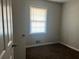 Simple bedroom with brown carpet and window at 10650 Panhandle Rd, Hampton, GA 30228