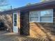 Brick home exterior showcasing a wooden deck and windows at 10650 Panhandle Rd, Hampton, GA 30228