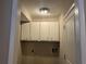 Small laundry room with overhead cabinets at 10650 Panhandle Rd, Hampton, GA 30228