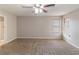 Large main bedroom with ceiling fan, carpet, and neutral-colored walls at 1363 Stoneleigh Way, Stone Mountain, GA 30088