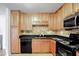 Well-equipped kitchen featuring granite countertops and wood cabinets at 1468 Briarwood Ne Rd # 1307, Brookhaven, GA 30319