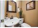 Small bathroom with white pedestal sink and toilet at 6103 Governors Walk Dr, Canton, GA 30115