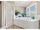 Bathroom with soaking tub and large window at 6103 Governors Walk Dr, Canton, GA 30115