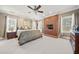 Main bedroom with fireplace and large windows at 6103 Governors Walk Dr, Canton, GA 30115
