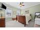 Upstairs bedroom with wood sleigh bed and ceiling fan at 6103 Governors Walk Dr, Canton, GA 30115