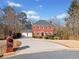 Brick home with two-car garage and landscaped yard at 6103 Governors Walk Dr, Canton, GA 30115