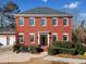 Brick home with a covered front porch and landscaping at 6103 Governors Walk Dr, Canton, GA 30115