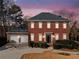 Brick two-story house with a two-car garage and landscaped yard at 6103 Governors Walk Dr, Canton, GA 30115