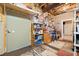 Basement workshop with storage shelves, workbench and door at 6103 Governors Walk Dr, Canton, GA 30115