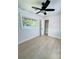 Spacious bedroom featuring a ceiling fan, window, closet, and light wood-look flooring at 1807 W Austin Rd, Decatur, GA 30032