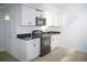 Modern kitchen with white cabinets, black appliances, and granite countertops at 1807 W Austin Rd, Decatur, GA 30032