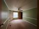 Bedroom with built-in shelving and ceiling fan at 3520 Haynes Ridge Rd, Loganville, GA 30052