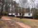 White mobile home with deck, trees in background at 3520 Haynes Ridge Rd, Loganville, GA 30052