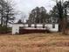 Back of the mobile home with a deck and yard at 3520 Haynes Ridge Rd, Loganville, GA 30052