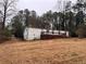 Side view of mobile home, deck, wooded area at 3520 Haynes Ridge Rd, Loganville, GA 30052