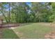 Large backyard with lush trees and grassy area at 4761 Lincoln Ne Dr, Kennesaw, GA 30144