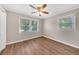 Well-lit bedroom featuring wood-look floors and multiple windows at 4761 Lincoln Ne Dr, Kennesaw, GA 30144