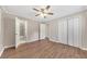 Bright bedroom with wood-look floors, ceiling fan, and spacious closet at 4761 Lincoln Ne Dr, Kennesaw, GA 30144