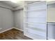 Bright walk-in closet with shelving and hanging rods at 4761 Lincoln Ne Dr, Kennesaw, GA 30144