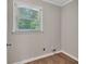 Bright laundry room with wood-look flooring and window at 4761 Lincoln Ne Dr, Kennesaw, GA 30144